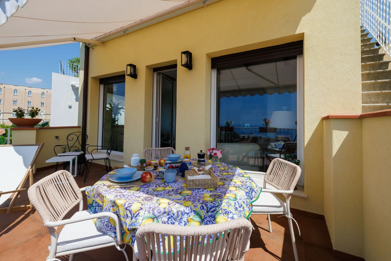 the breakfast terrace, with its awning and the view of the bell tower