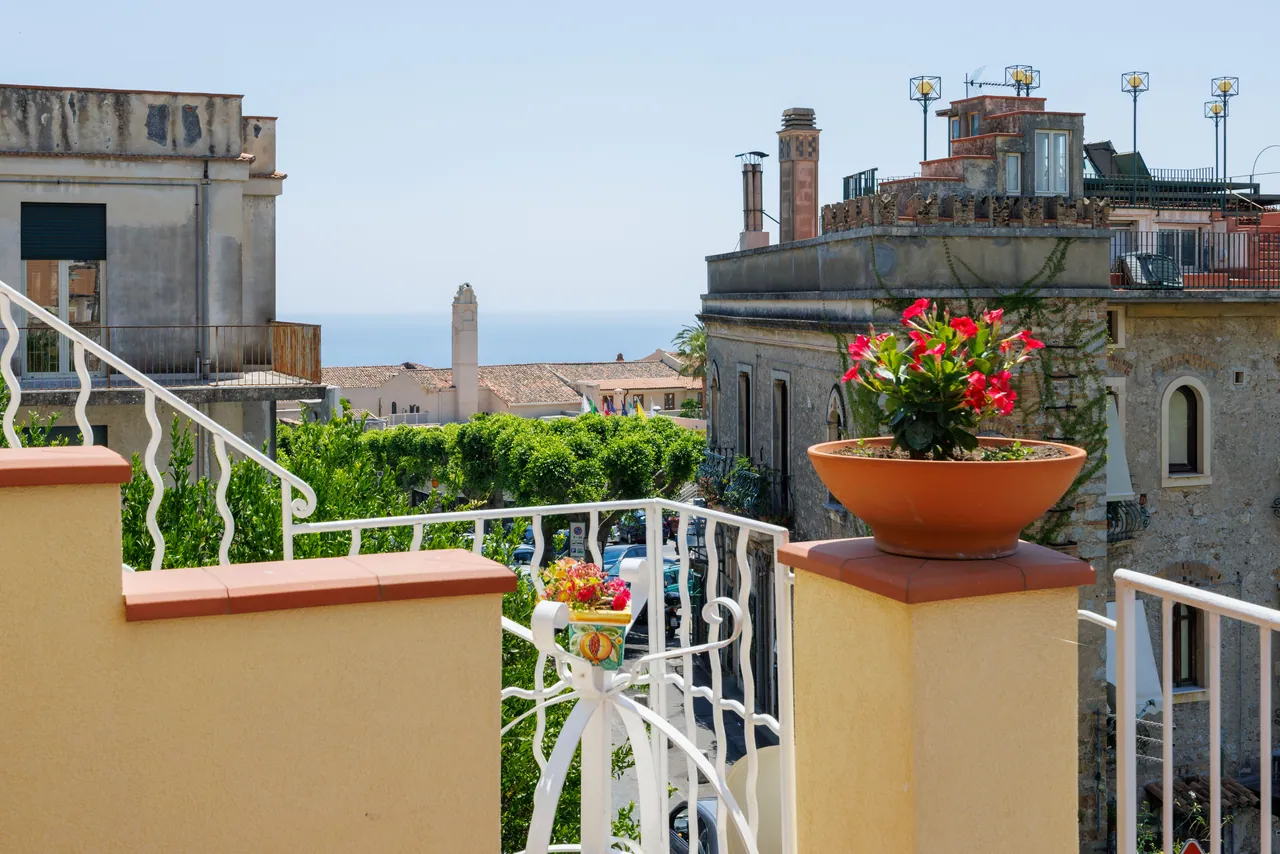 the breakfast terrace, with its awning and the view of the bell tower