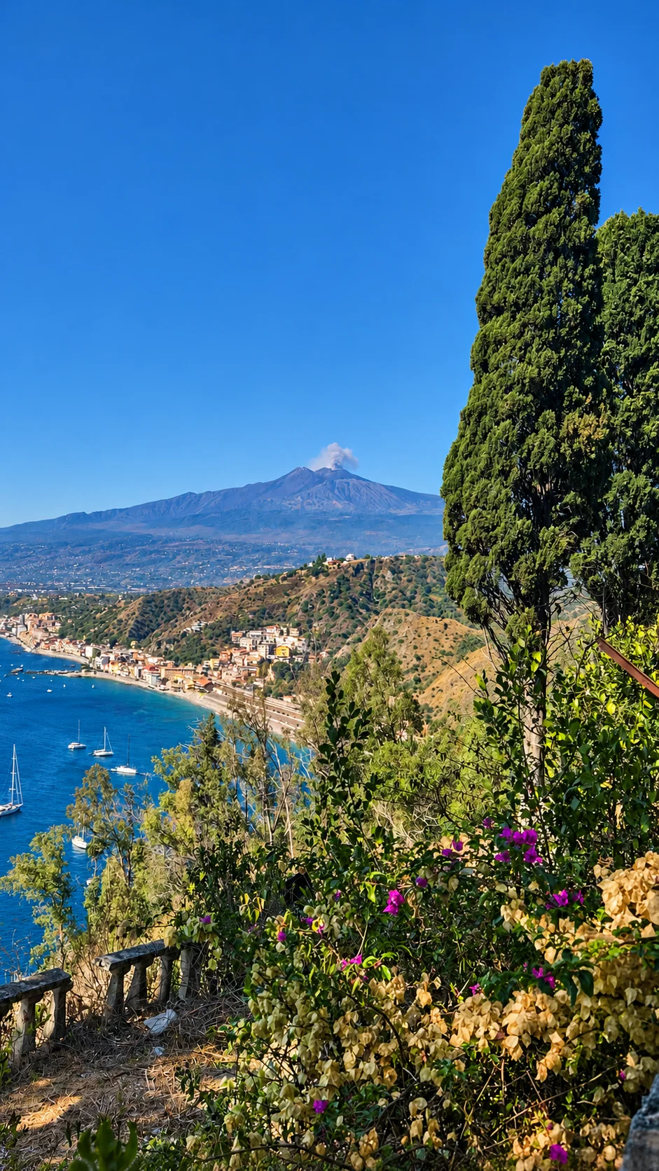 Etna seen through the bougainvillea of the old town